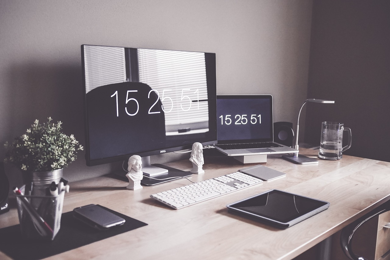 A workspace with office supplies neatly organized and sorted