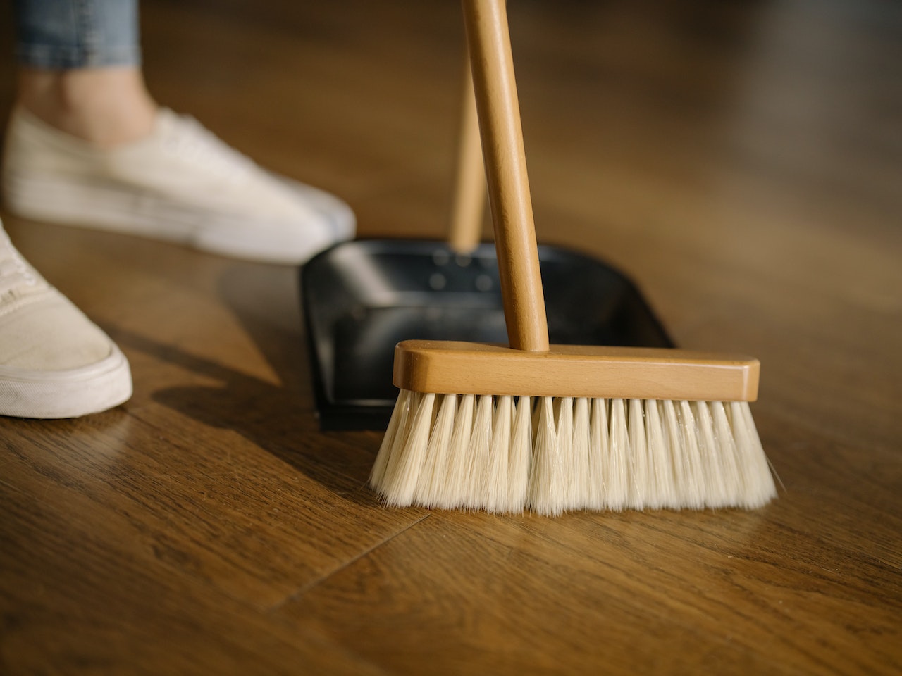 A person sweeping their floors