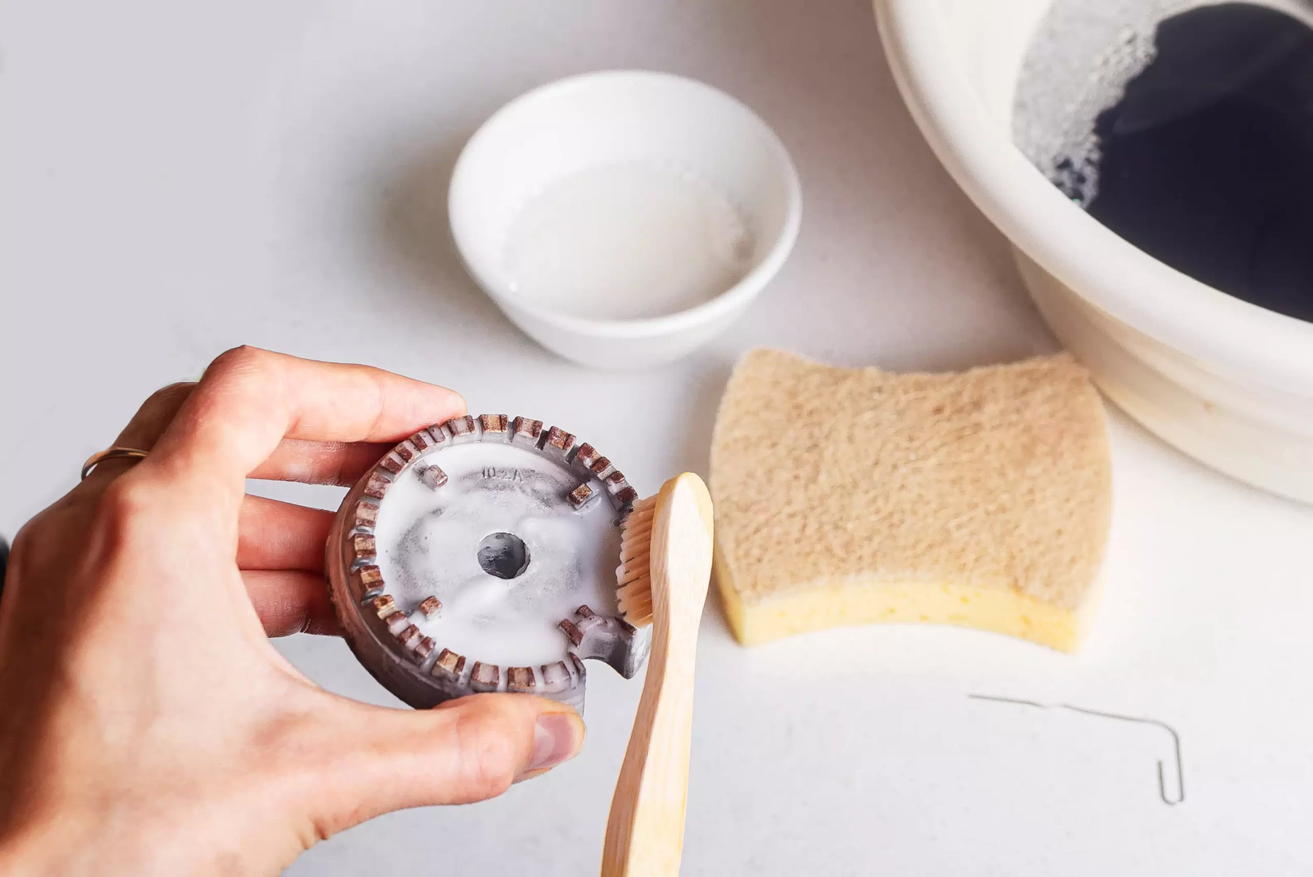 scrubbing burner parts with a toothbrush